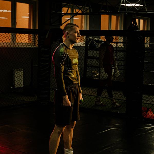 Athlete focused during a workout session with amber light effect.